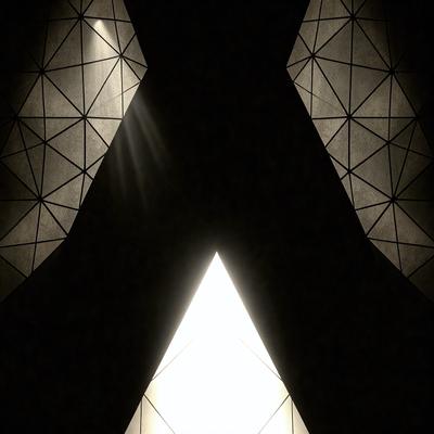 The primary subject of the image is a large, illuminated triangle. The setting is a dark room, and the visual style appears to be a combination of a photo and digital art. The dominant colors are black and white, creating a moody atmosphere.